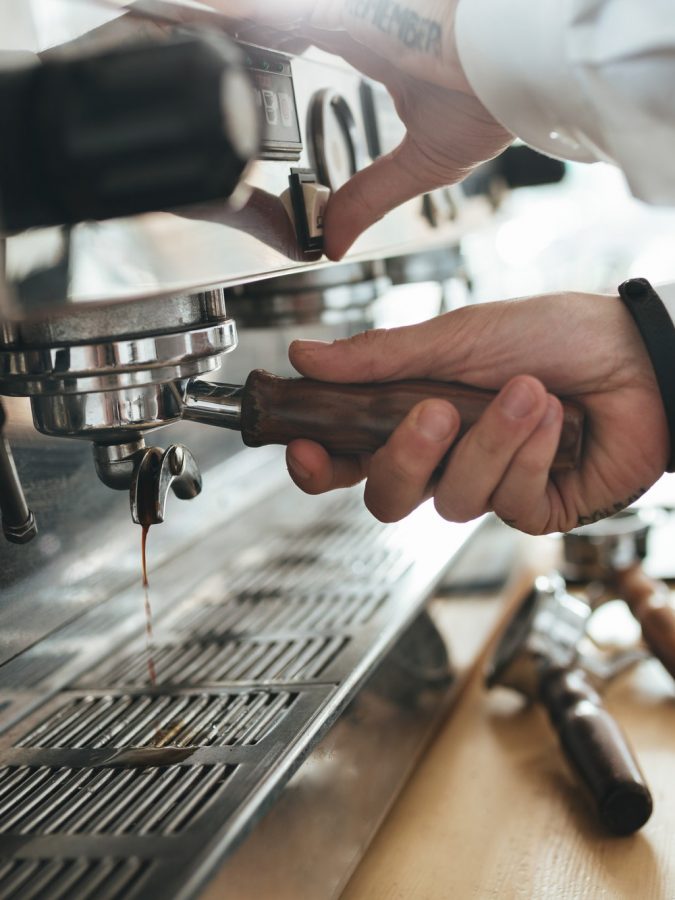 Man hands working with coffee machine at cafe